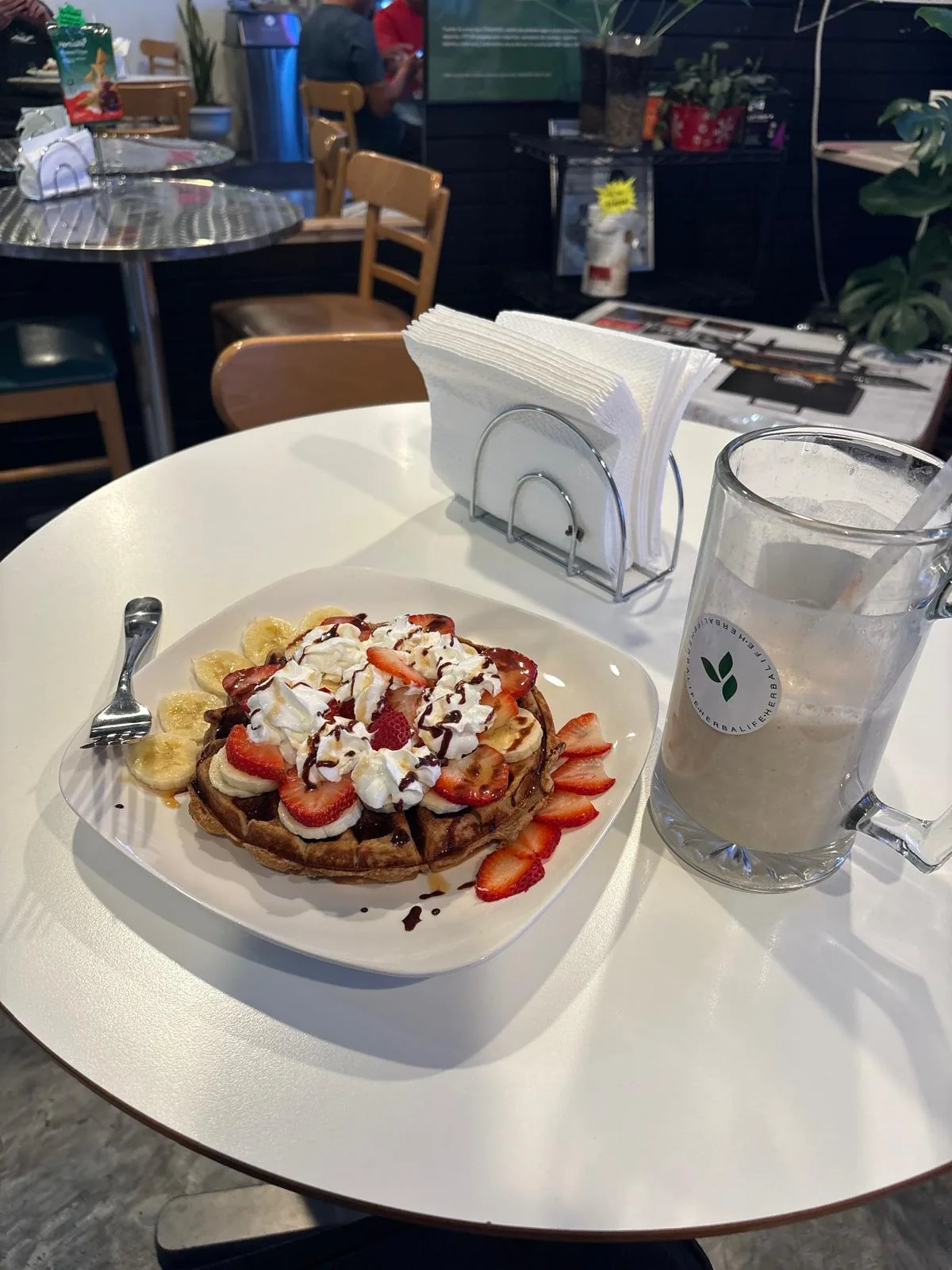 Protein waffle with strawberries, banana, and whipped cream at My Casa Nutrition